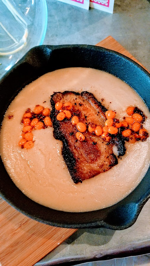 Belarusian pork belly machanka. pan gravy, blini and sea buckthorn berries