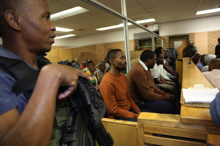 ANC councillor Nkosinathi Gambu (extreme left wearing an orange jersey) and his co-accused appeared in the PMB Regional court. The 6 are accused of killing ANC Councillor Thamsanqa Mchunu who was gunned down outside his home in KwaPata in Pietermaritzburg.