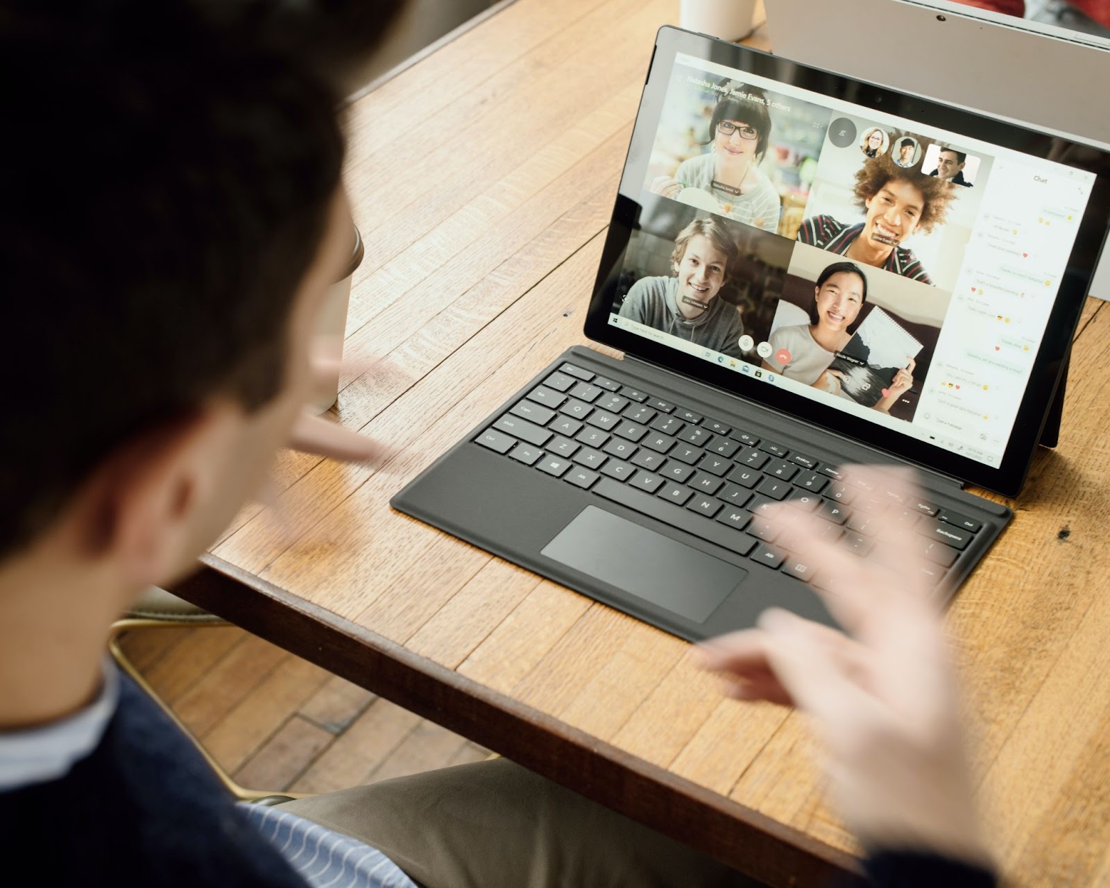 A laptop displaying the faces of participants on a video conference call