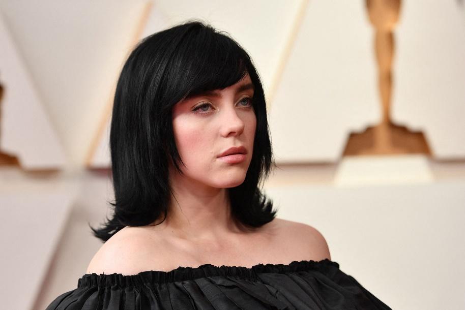 headshot of Billie Eilish with black bob and side swept bangs