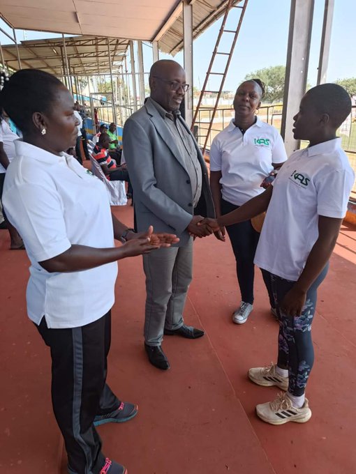 AK youth sub-committee and development chairman Barnaba Korir talks to sprints prodigy Selpha Ajiambo in Kisumu. Kenya Sports Academy CEO Doreen Odhiambo (2nd R) looks on.