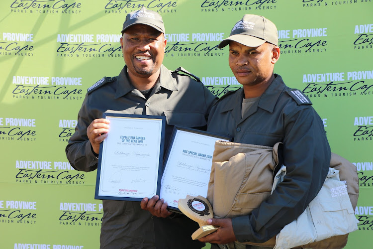 Economic development ,environmental affairs and tourism MEC Oscar Mabuyane handing over the ECPTA Field ranger of the year and the MEC Special awards to Lukhanyo Nyamezele.