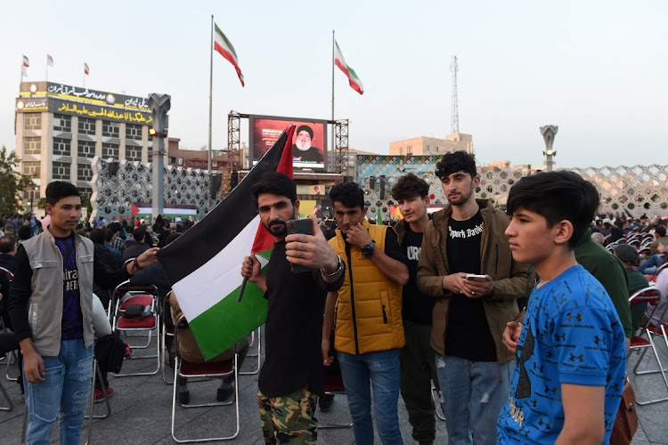 People listen to Hezbollah leader Sayyed Hassan Nasrallah's speech through a screen during a gathering in support of Palestinians, amid the ongoing conflict between Israel and the Palestinian Islamist group Hamas, in Tehran, Iran, on November 3 2023.