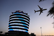 A Gulf Air plane flies over the grid prior to the F1 Grand Prix of Bahrain at Bahrain International Circuit on March 28 2021.