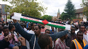 Foreigners looking ready to defend themselves as they hold their ground at Luttig street.