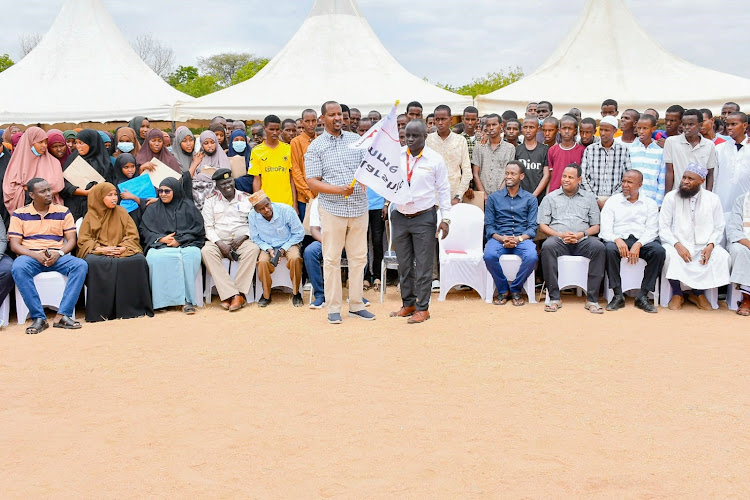 Garissa Equity Bank branch manager Shadrack Muithya and Garissa Township MP Dekow Mohamed during the unveiling of the beneficiaries of the Elimu Scholarship.