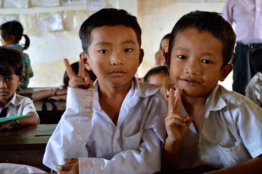 Two inquisitive young boys in their schoolhouse in Vietnam. 