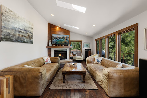 Living room with brown leather sofas, fireplace in this luxury property for sale in Carnelian Bay ($1,495,000 - 193 m²)