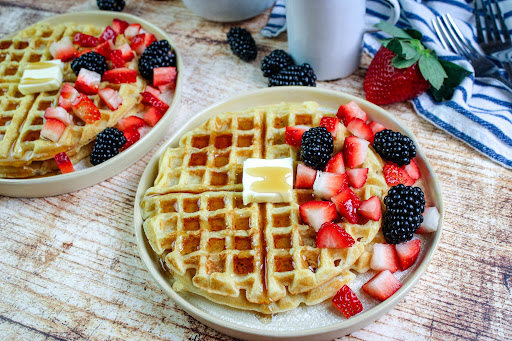 Delicious Buttermilk Waffles with syrup, butter, and berries.