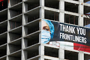 A banner thanking front-line health workers hangs on a high-rise building construction site during the outbreak of Covid-19 in St Julian's, Malta, on April 14 2020. 