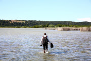 Bonginkosi Thusi wades through Kosi Bay on his way to school. Some children who live in the area have to cross crocodile- and hippo-infested waters to get to school. /Thuli Dlamini