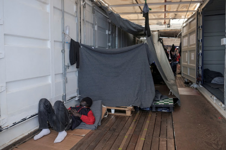 A migrant rests on deck of a ship in the Mediterranean Sea on November 8 2022.