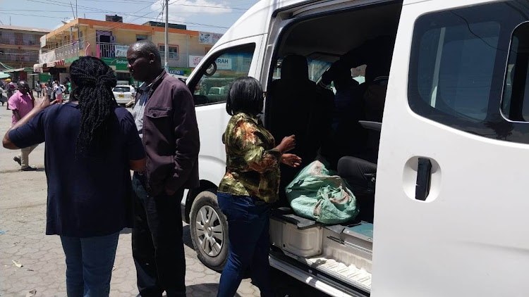 Arrested traders escorted to awaiting van belonging to Nema during the crackdown operations on banned plastic bags in Mlolongo, Machakos county on January 30, 2023.