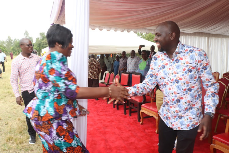 Homa Bay Governor Gladys Wanga greets Transport Cabinet Secretary Kipchumba Murkomen at Nyalienga Catholic church in Rangwe constituency on August 6,2023