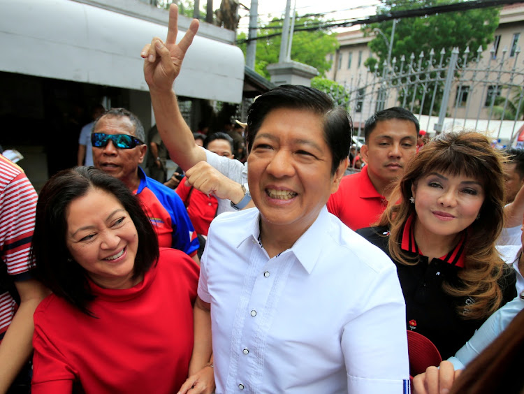 Ferdinand "Bongbong" Marcos, son of late dictator Ferdinand Marcos, his wife, Louise (L) and his sister Imee (R) smile upon arrival at the Supreme Court in Padre Faura, Metro Manila, Philippines on April 2 2018. Picture: REUTERS/ROMEO RANOCO