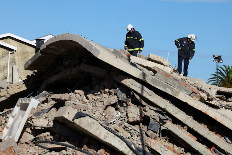 Rescuers search for construction workers trapped under a building that collapsed in George.