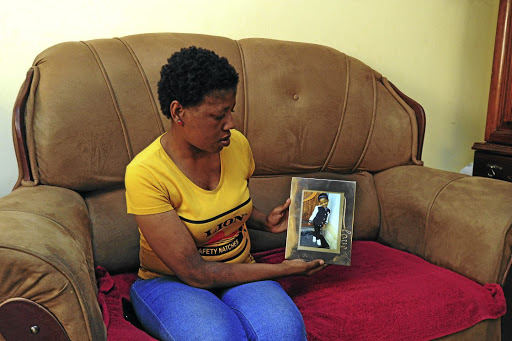 Nokulunga Nkosi with a picture of her daughter, Amahle, who disappeared two years ago.