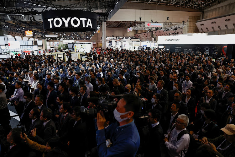 Attendees listen as president, CEO and member of the board of directors at Toyota Motor, Koji Sato, speaks at the Japan Mobility Show 2023 at Tokyo Big Sight in Tokyo, Japan, on October 25, 2023. REUTERS/ISSEI KATO