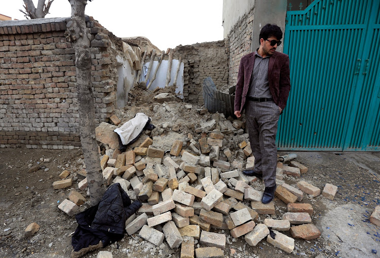 A man stands near the debris at one of the explosion sites in Kabul, Afghanistan, March 21, 2019.