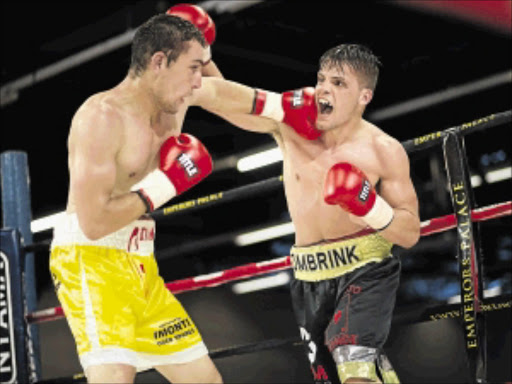 PACKING PUNCHES: Giovanni Bushby and Gauteng middleweight champion Dowayne Combrink exchange heavy leather in their eight-rounder at Emperors Palace on Wednesday night. Combrink outpointed his foe in the main contest of African Ring's Christmas Cracker bill PHOTO: n-squared