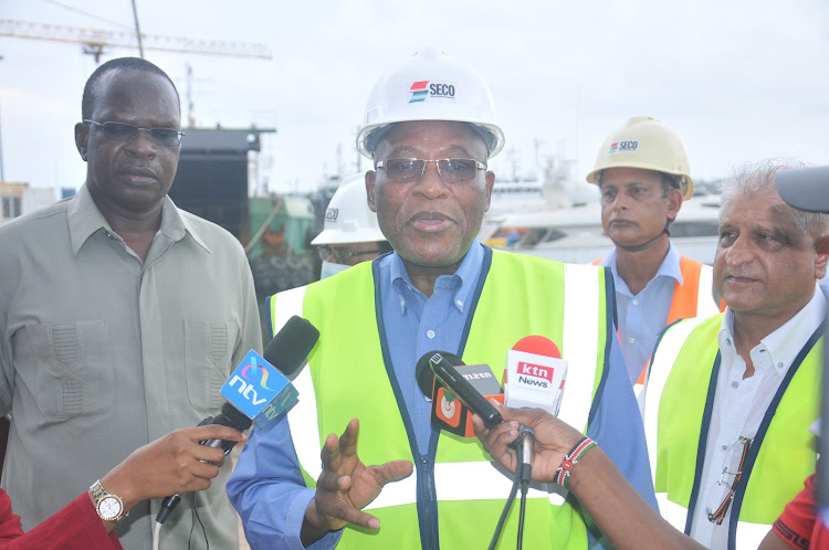 Southern Engineering Company director John Msafari, flanked by Coast regional commissioner John Elungata speaks to the press at Seco Yard in Mombasa