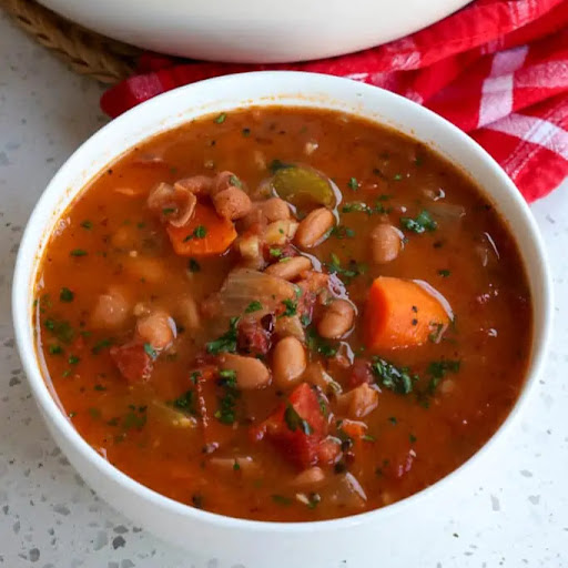 Quick and easy Pinto Bean Soup with onions, celery, carrots, tomatoes, and pinto beans in a vegetable broth seasoned with smoked paprika, marjoram, and cumin. 