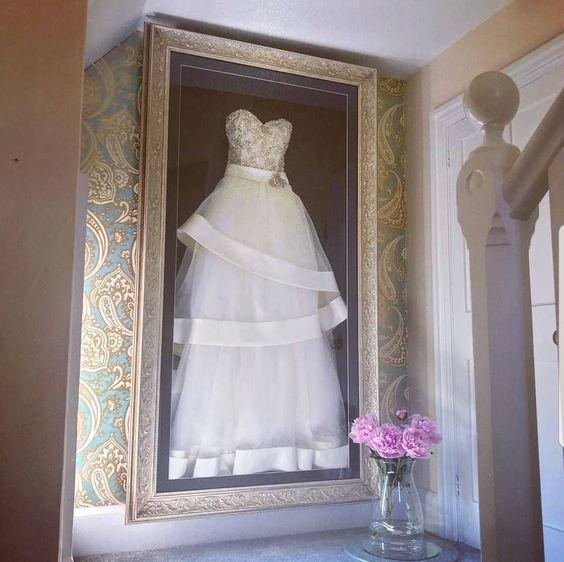 a wedding dress inside a see through glass 