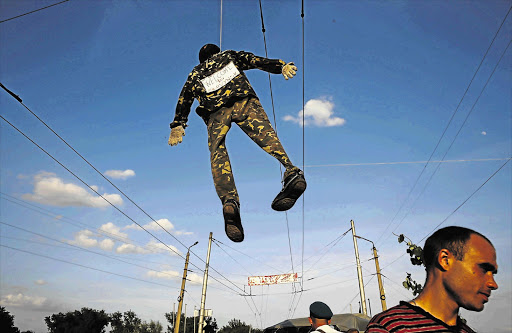 NO END TO CRISIS: An effigy of a Ukrainian soldier hangs over a pro-Russian barricade on the outskirts of Slaviansk, in eastern Ukraine, ahead of yesterday's separatist referendum. The referendum went ahead despite threats by the West of more sanctions against Russia