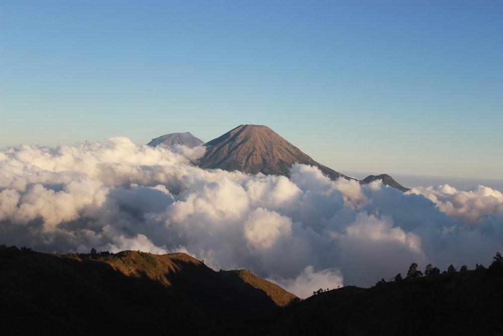 clouds under hill at daytime