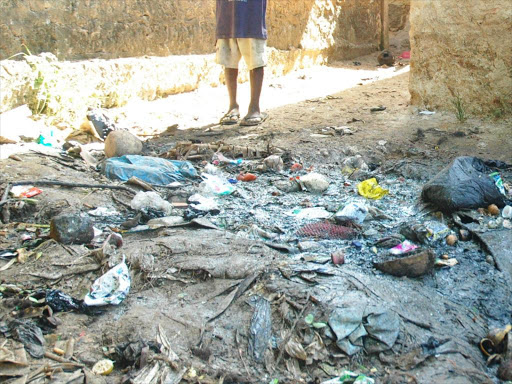 "A child stands near garbage in Owino Uhuru slums in Mombasa county where a metal company was accused of causing lead poisoning through industrial waste."