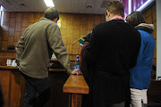 The 17-year-old boy convicted of murder talks to friends and family at the Kimberley High Court. File photo.