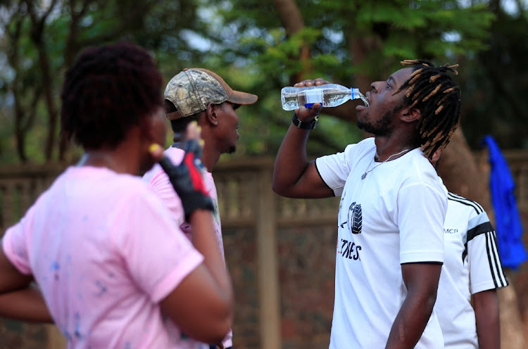 People take a break during an early morning exercise inside Warren Hills cemetery in Harare, Zimbabwe, November 24 ,2022.