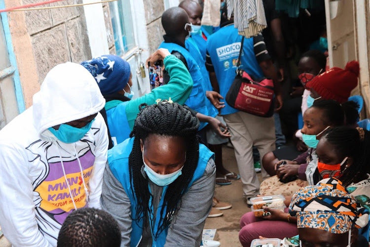 Various families receive food from Shofco staff