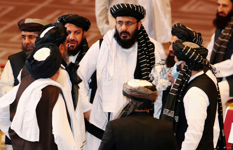 Taliban delegates speak during talks between the Afghan government and Taliban insurgents in Doha, Qatar September 12, 2020.