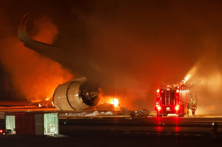 Firefighters work at Haneda International Airport after Japan Airlines' A350 airplane caught on fire, in Tokyo, Japan on January 2 2024. Picture: REUTERS/Issei Kato