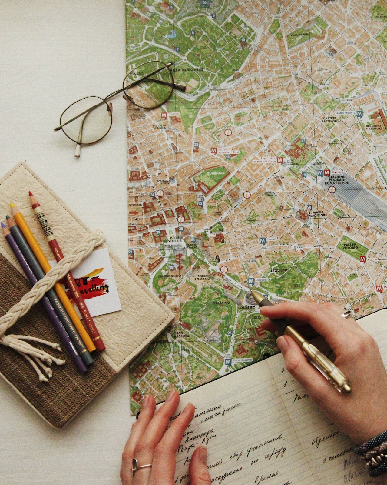 Eyeglasses on a map photo - a person holding a pen interpreting data & preparing for GAT.