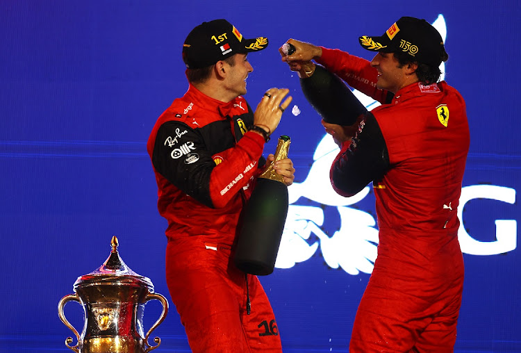 Race winner Charles Leclerc of Monaco and Ferrari and second-placed Carlos Sainz of Spain and Ferrari celebrate on the podium after the F1 Grand Prix of Bahrain at Bahrain International Circuit on March 20 2022.