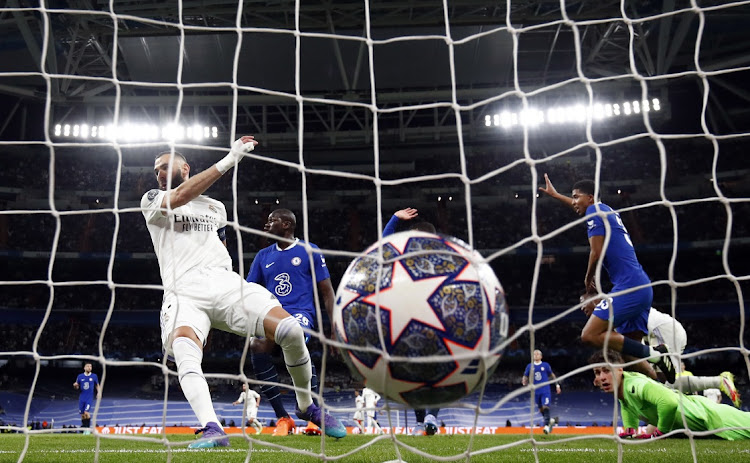 Real Madrid's Karim Benzema scores their first goal in the Uefa Champions League quarterfinal first leg match against Chelsea at the Santiago Bernabeu in Madrid on April 12 2023.