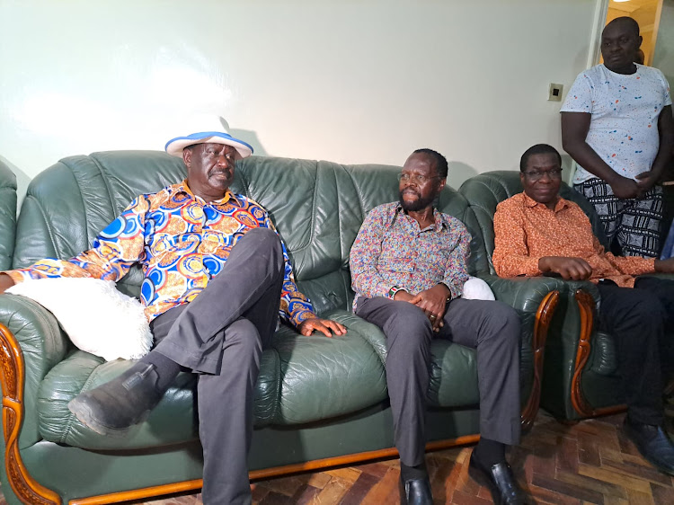 Raila Odinga at the home of Mama Grace Onyang'o in Kisumu accompanied by various leaders.