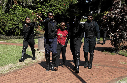 One of the four arrested students at DUT is led away yesterday./Sandile Ndlovu