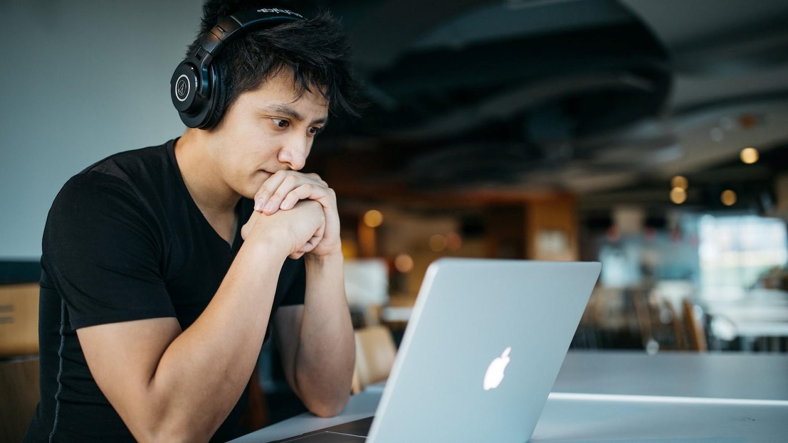 A person reading about HubSpot CRM on their laptop.