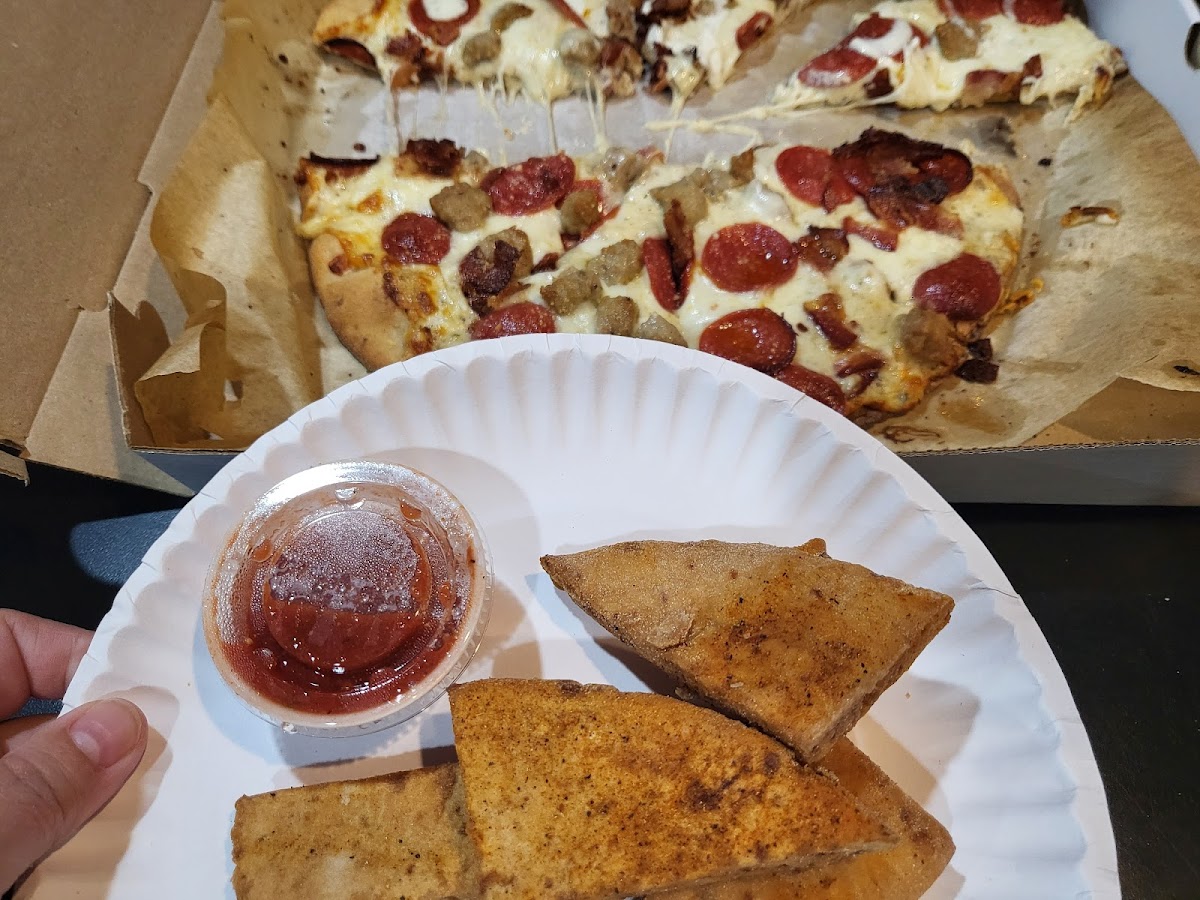 GF pizza with pepperoni, sausage, bacon and GF bread sticks