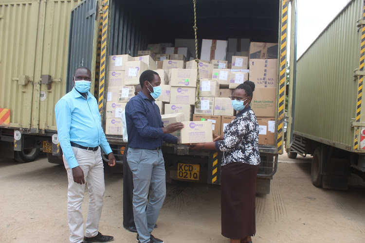 Turkana Health executive Jane Ajele (right) at Lodwar County Referral Hospital inspecting medical supplies worth Sh59 million from Mission for Essential Drugs and Supplies