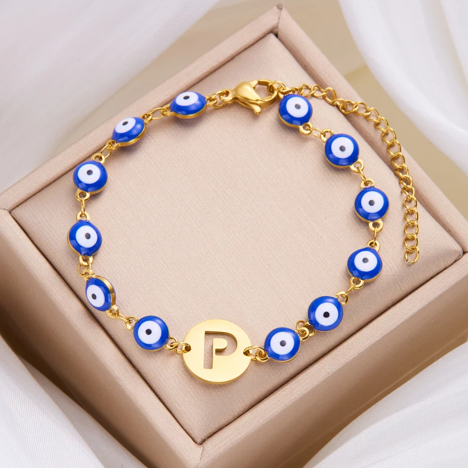 Bracelet femme en acier inoxydable haut de gamme, yeux bleus, lettres 26 ajourées, tendance, pour un look élégant et personnalisé.
