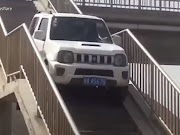 Stairs? Who cares? After missing his exit, the Jimny driver made a u-turn on a pedestrian overpass.
