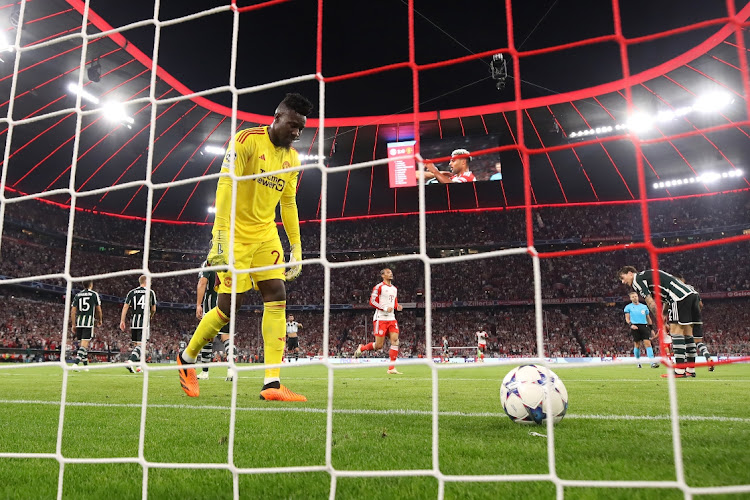 Manchester United goalkeeper Andre Onana reacts after Serge Gnabry of Bayern Munich scores their side's second goal during the UEFA Champions League match at Allianz Arena on September 20, 2023 in Munich