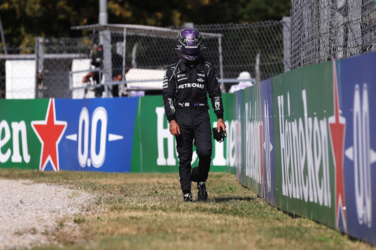 Lewis Hamilton walks back to the pits after crashing during the F1 Grand Prix of Italy at Autodromo di Monza on September 12 2021 in Monza.