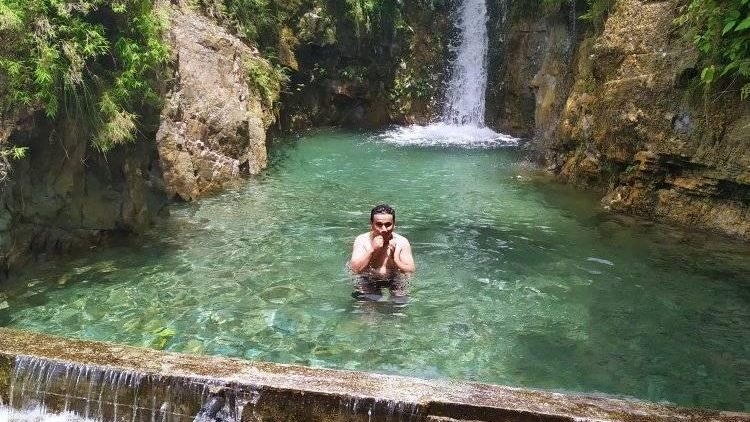 A guy dipped in a cold stream of Gairibari falls