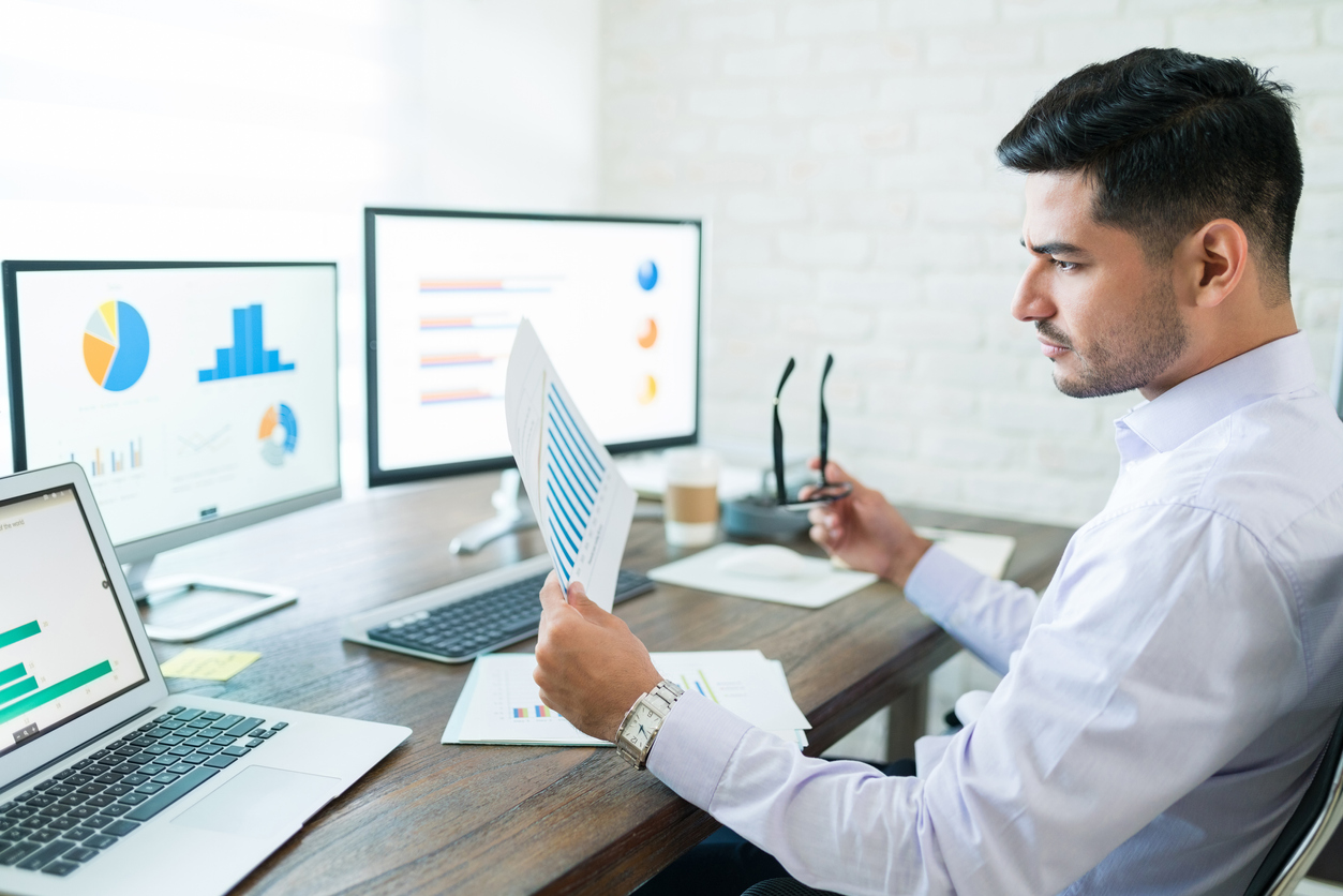 man in office looking at analytics