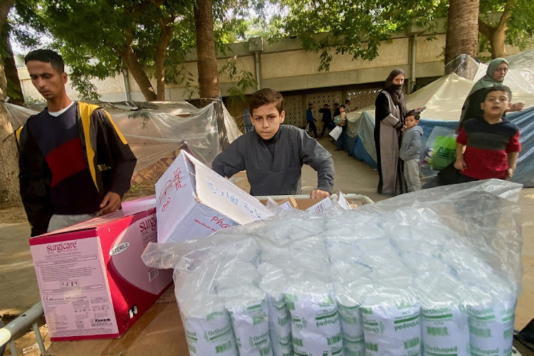 Yazan Fasfous, 13, volunteers to help distribute medical supplies at the European Gaza Hospital, where his mother works, amid the ongoing conflict between Israel and the Palestinian Islamist group Hamas, in Khan Younis, Gaza Strip, December 8, 2023.